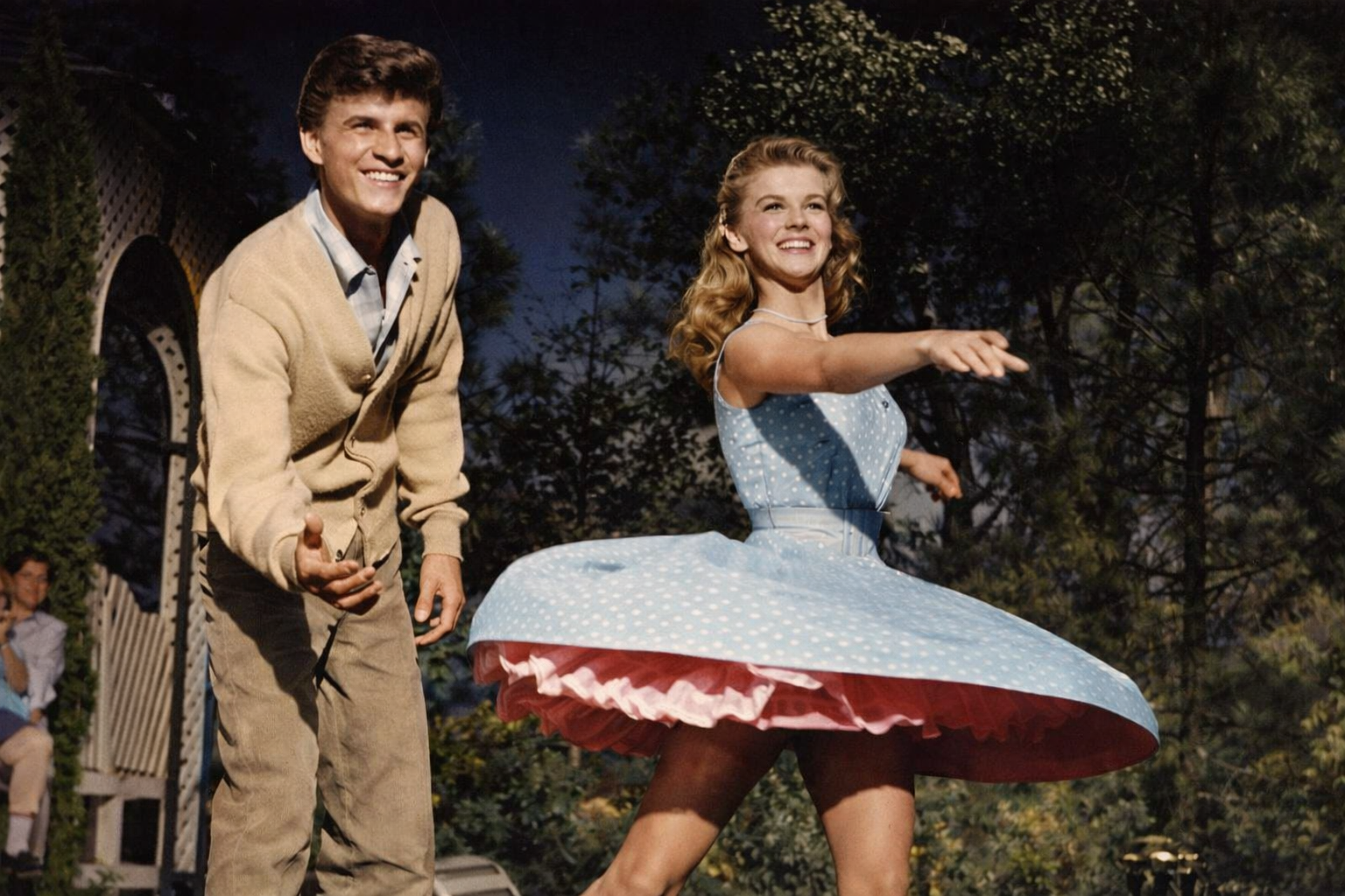 Scene from Bye Bye Birdie featuring Ann-Margret dancing in a blue dress during a lively musical performance.